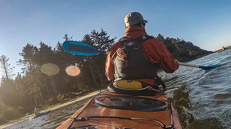 kayaker wearing dry gear and lifejacket from the back