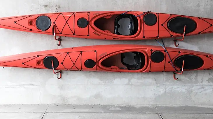 2 kayaks hung up on the wall