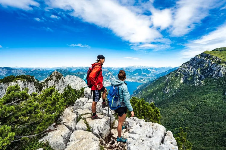 Two hikers at the top of a rocky cliff