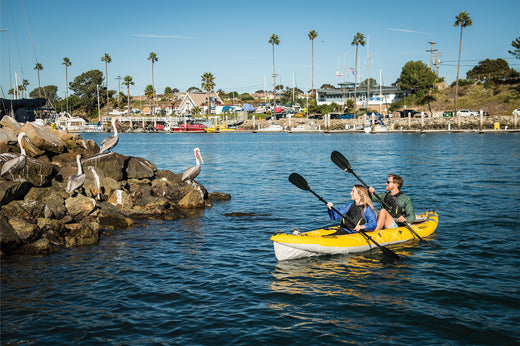 couple paddling a tandem inflatable kayak