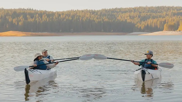 Family kayaking on the river in lifejackets