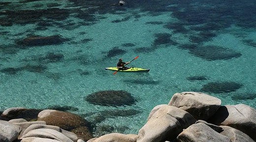 kayaker on clear sea water from a distance