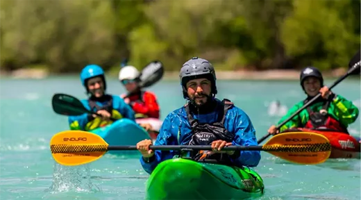 group of people paddling kayaks
