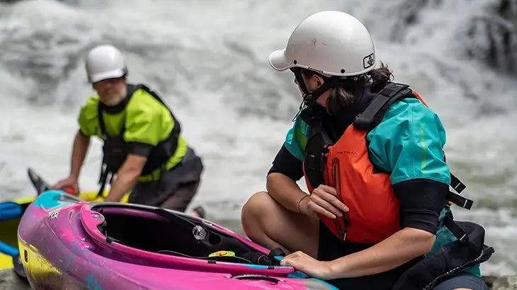 Man and Woman kayaking with kayak gear on