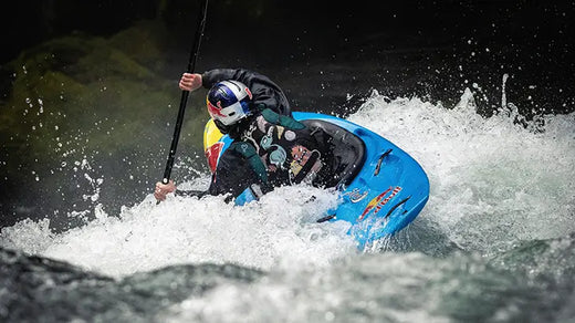 person maneuvering a kayak through river rapids from the back