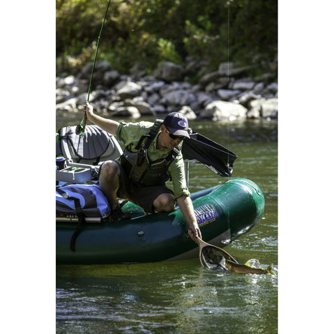 Outcast PAC 1300 Self-Bailing Raft  netting a fish