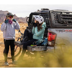 Kuat Ibex Truck Bed Rack in Sandy Black with two bikers