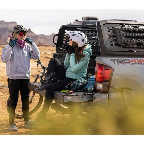 Kuat Ibex Truck Bed Rack in Sandy Black with two bikers
