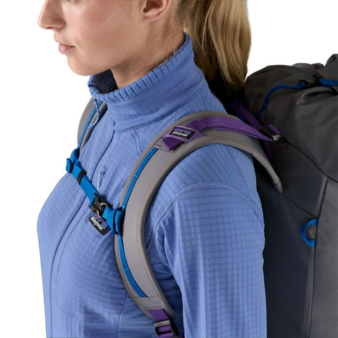 Patagonia Women's R1 Jacket in Abundant Blue close up of model wearing backpack