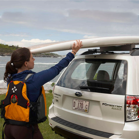 Malone Deluxe Stand-Up Paddle Board/Surfboard Roof Rack with woman loading boards