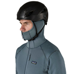 Patagonia Men's R1 Pullover Hoody closeup of model with hood on wearing a helmet angle view