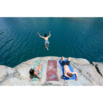 PackTowl Luxe Microfiber Beach Towel in Lake Blue in use