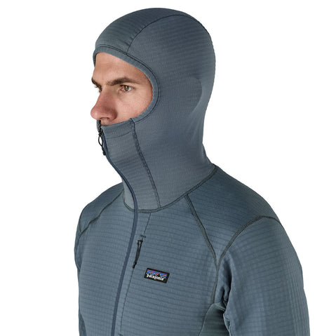 Patagonia Men's R1 Pullover Hoody close up of model with hood on angle view
