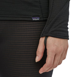 Patagonia Women's Capilene Thermal Weight Crew Shirt model in black close up of thumb loop