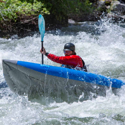 AIRE Outfitter I Inflatable Kayak in blue with a kayaker