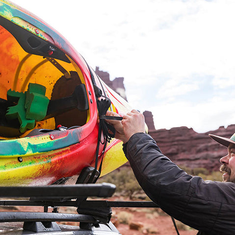 Kuat Class 2 J Cradle Roof Rack Kayak Carrier tying down a kayak