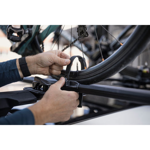 Thule FastRide Bike Roof Rack in Black close up of wheel being strapped into tray