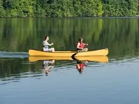 Couple rowing canoe